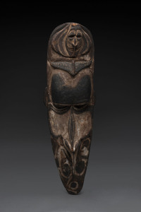 A mask, carved wood with piped clay and ochre finish, Papua New Guinea, 86cm high