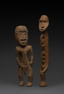 Two standing figures, carved wood with yellow earth pigment, Papua New Guinea, ​39cm and 34cm high