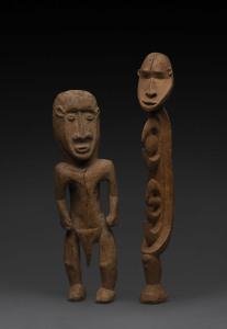 Two standing figures, carved wood with yellow earth pigment, Papua New Guinea, 39cm and 34cm high