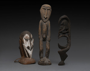 A double sided bust and two standing figures, carved wood, shell and earth pigments, Papua New Guinea, (3 items), 19cm, 34cm and 28cm high