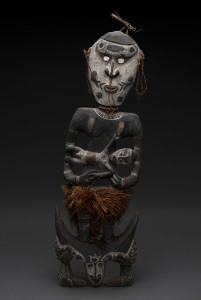 A figural food hook, carved wood, fibre, shell and earth pigments, Papua New Guinea, 86cm high