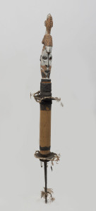 A flute stopper with bird totem, carved wood, feather, fibre, shell and earth pigments, Papua New Guinea, ​105cm high
