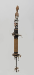 A flute stopper with bird totem, carved wood, feather, fibre, shell and earth pigments, Papua New Guinea, 105cm high