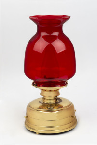 A brass oil lamp with ruby glass shade (electrified), 42cm high