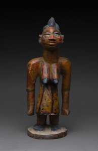 A standing female figure, carved wood with polychrome finish, Yoruba tribe, Nigeria, 44cm high