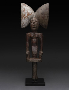 Shango staff with kneeling figure, carved wood with remains of polychrome finish, Yoruba tribe, Nigeria, later wooden stand, 49cm high