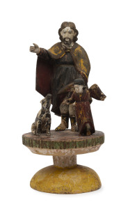 A carved wood with polychrome finish group depicting St. Roch (or Rokkus), with the dog offering him bread and attended by an angel, 19th century, 35cm high. Among his many attributes, St. Roch is the Patron Saint of bachelors, dogs, falsely accused peop