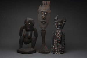 Three tribal artefacts, carved wood, shell and earth pigments, Papua New Guinea, the largest 64cm high