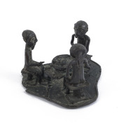 A sculpture of three seated figures, cast bronze, Ashanti tribe, Ghana, ​6.5cm high, 8cm wide