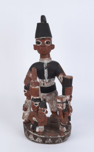 A figural group, carved wood with earth pigments, Yoruba tribe, Nigeria, 62cm high