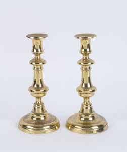 A pair of antique brass candlesticks, 19th century, 25cm high