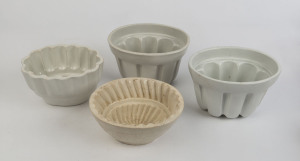 Four antique porcelain jelly moulds, 19th and early 20th century, the largest 13cm high, 21cm wide