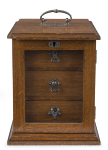 An antique collector's cabinet, oak with nickel plated fittings and glass door, late 19th century, 23cm high, 17cm wide, 18cm deep