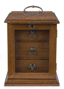An antique collector's cabinet, oak with nickel plated fittings and glass door, late 19th century, ​23cm high, 17cm wide, 18cm deep