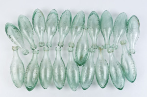 "C.R. MOORE DAYLESFORD, ESTABLISHED 1862" group of twenty torpedo glass bottles, 19th century, ​23.5cm high