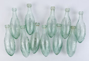 "C.R. MOORE DAYLESFORD, ESTABLISHED 1862" group of eleven torpedo glass bottles, 19th century, 23.5cm high