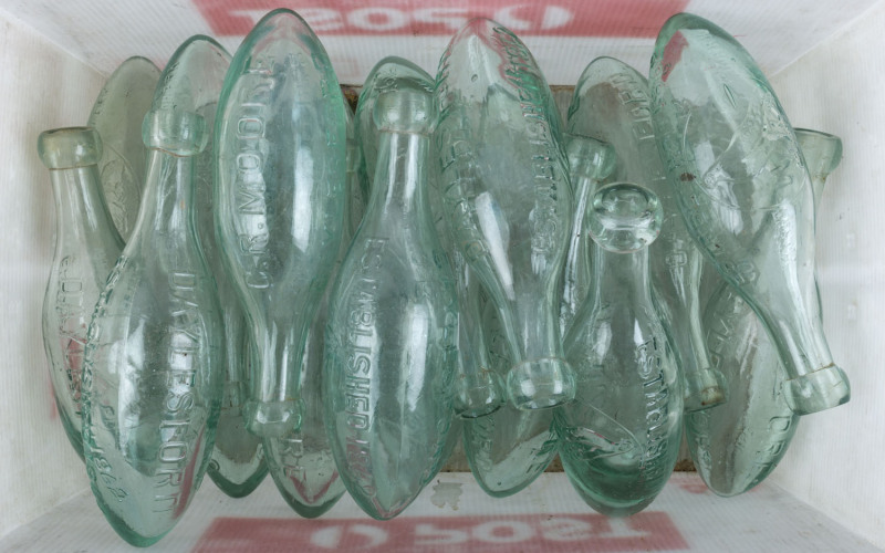 "C.R. MOORE DAYLESFORD, ESTABLISHED 1862" group of twenty torpedo glass bottles, 19th century, 23.5cm high