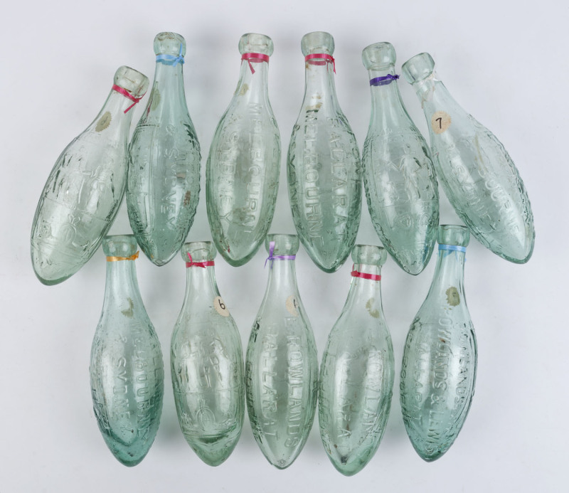 "E. ROWLAND, BALLARAT, MELBOURNE & SYDNEY" GROUP OF ELEVEN "Miner and Farmer" glass torpedo bottles, 19th century, ​24.5cm high