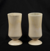 A pair of marine ivory rum cups, 19th century, ​7cm high