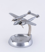 A chrome aeroplane desk ashtray ornament, circa 1940s, 11cm high, 13cm long