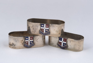 Set of three silver plated napkin rings with enamelled Melbourne crests, circa 1900, 6.5cm wide