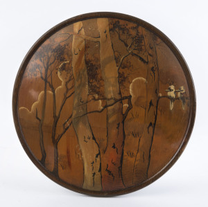 A circular Australiana panel, hand-painted on huon pine, circa 1925, 24cm diameter