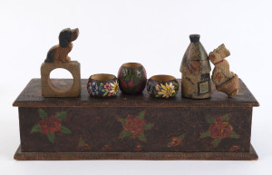 An Australian pokerwork box, four napkin rings, a cottage ornament and a bottle stopper, early 20th century, the box 37cm wide