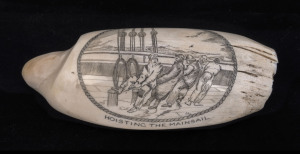A scrimshaw whale's tooth titled "Hoisting The Mainsail", signed "J.F.C.", 20th century, 16cm long