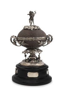 JULIUS SCHOMBURGK Impressive Australian Colonial silver mounted emu egg casket adorned with Aboriginal figures in a wrestling pose, the base featuring a kangaroo and emu amongst ferns and foliage, interior with original gilt wash finish, mounted on an ebonized plinth with silver fittings, South Australian origin, mid 19th century.