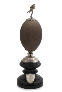 ARMFIELD Australian silver mounted emu egg trophy on ebonized wooden plinth with silver shield inscribed "Presented By GEO. H. BENNETT Esq. For TANNERS & CURRIERS HANDICAP Won By W. SCOTT", Collingwood, Melbourne origin, 19th century, stamped "G. ARMFIELD, STERLING SILVER, COLLINGWOOD", 33cm high