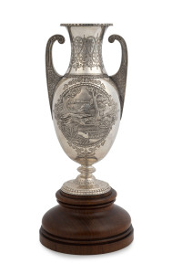 EDWARD FISCHER (attributed) "Sunbury Cup" Colonial silver coursing trophy in the neo-classical style, impressively decorated with dog portrait and coursing scene vignettes, engraved "NICODEMUS Winner Of The Sunbury Cup, Being The First Run For In The Colony, Owned and Bred By Frederick Row, 1873", mounted on a Tasmanian blackwood plinth, trophy 27cm high, 35.5cm overall