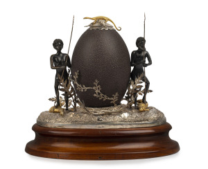 J. M. WENDT a superb Australian desk set, Colonial silver and emu egg decorated with Aboriginal figures, kangaroo, emu and goanna finished gilded highlights, mounted in a rocky form landscape with ferns and leaves, original blackwood plinth base, 19th century, stamped "J. M. W." with crown and lion marks, 22cm high, 22cm wide, 16cm deep