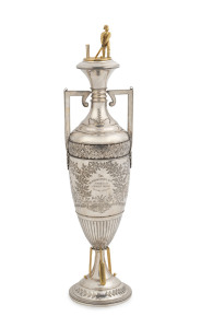 HENRY YOUNG & Co. important Australian silver cricket trophy adorned with gilded batsman and wicket, cricket bats, balls and stumps, engraved "The Melbourne Sports Depot. Junior Cricket Club Trophy, Season 1884 & 5. Won By The Dudgeon & Arnell C.C., Prese