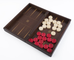 A timber folding games box with turned whalebone draughts pieces, 19th century, the board 38cm wide