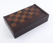 A timber folding games box with turned whalebone draughts pieces, 19th century, the board 38cm wide - 2