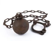 A convict ball and chain with leg iron attached, early to mid 19th century, ​ball diameter 12cm