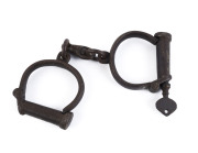 HIATT & Co. antique handcuffs with original key, 19th century, factory stamp partially legible, ​23.5cm wide