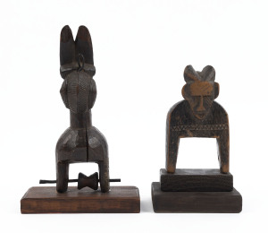 Two African weaving pulleys, carved wood, Baule tribe, Ivory Coast, on later wooden plinths, 18cm and 23cm high overall