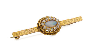 An antique gold bar brooch set with sold opal surrounded by old cut diamonds, 19th century, stamped "9ct", ​5.75cm wide, 5.7 grams