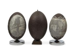 Two Australian carved emu eggs with Aborigines and native animals together with an uncarved specimen, early 20th century (3 items)