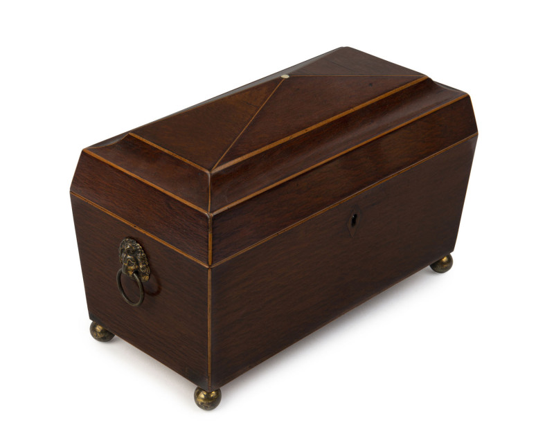 A Regency tea caddy, casuarina and pine with brass lion handles and bun feet, circa 1825, interior fitted with casuarina compartments and glass mixing bowl, 22cm high, 31cm wide, 15cm deep