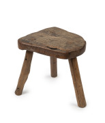 A primitive Australian three legged stool, slab red gum top with eucalypt legs, most likely central Victoria, 19th century, 31cm high, 41cm wide