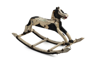 An Australian folk art rocking horse, painted timber, iron, leather and rubber, early 20th century, 75cm high, 124cm wide, 46cm deep PROVENANCE: Ex Toby & Juliana Hooper Collection