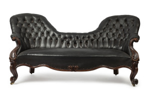 A Colonial double ended settee, finely carved cedar frame with contemporaneous black oil cloth upholstery, Tasmanian origin,19th century, 99cm high, 205cm wide, 95cm deep