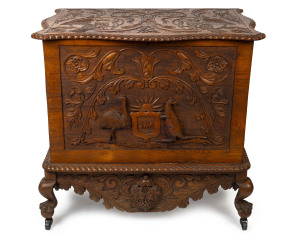 An impressive "ADVANCE AUSTRALIA" oak glory box, profusely carved with kookaburras, snakes, kangaroo and emu flanking a monogrammed crest "J.M.", the interior handsomely adorned with carved bird and swag emblazoned "With Best Wishes", circa 1880 95cm high, 105cm wide, 66cm deep