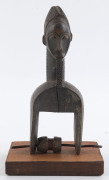 Two African weaving pulleys one with original spool, carved wood, Baule tribe, Ivory Coast, on later wooden plinths, 21cm and 24.5cm high overall - 9