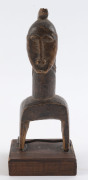 Three African weaving pulleys, carved wood, Baule tribe, Ivory Coast, on later wooden plinths, 17cm, 18cm and 20cm high overall - 13