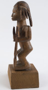 An African male fetish figure with gun and knife, carved wood, Babembe tribe, Congo area, on later wooden plinth, 28cm high overall - 3