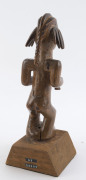 An African male fetish figure with gun and knife, carved wood, Babembe tribe, Congo area, on later wooden plinth, 28cm high overall - 4