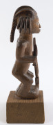 An African male fetish figure with gun and knife, carved wood, Babembe tribe, Congo area, on later wooden plinth, 28cm high overall - 5